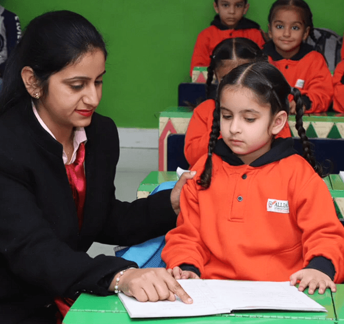 AIS teacher guiding reading in the school library