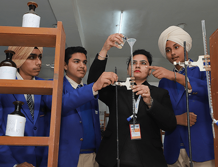 AIS teacher facilitating science experiment with students