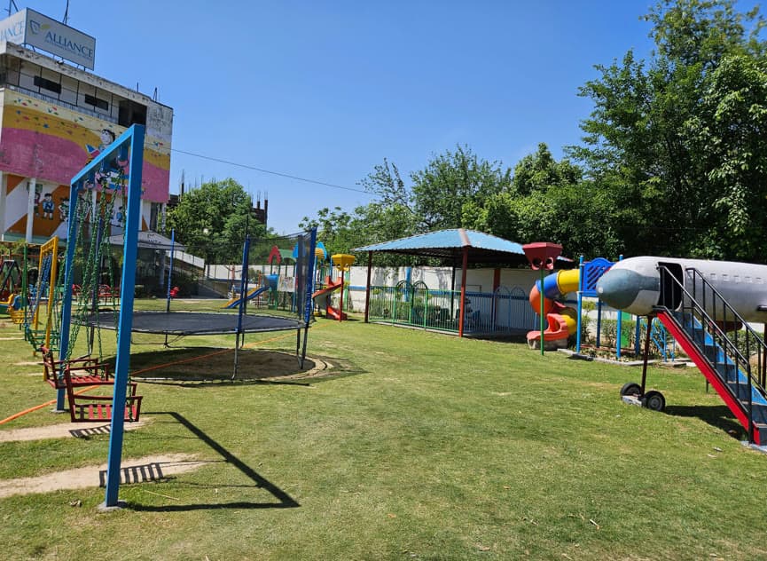 AIS early-years play zone with swings, trampoline and shaded gazebo
