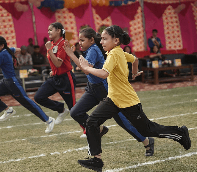 Teacher coaching students on sports field